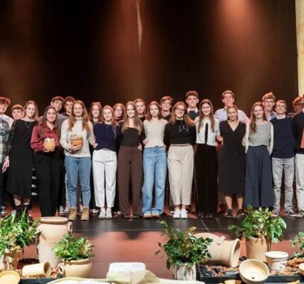 group of students on stage receiving awards