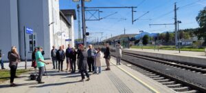 tour group waiting by the train tracks