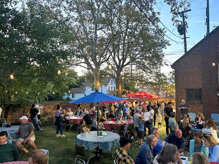 outdoor tables and chairs with guests enjoying a pop up beer garden