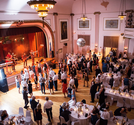 slovenian national home main hall with a large party of dancing guests