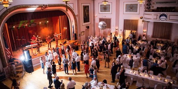 slovenian national home main hall with a large party of dancing guests