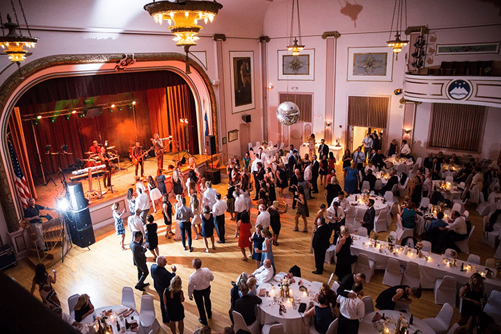slovenian national home main hall with a large party of dancing guests