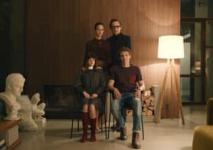 family of four posing in living room