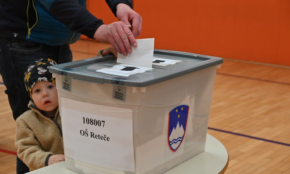 citizen voting with child watching
