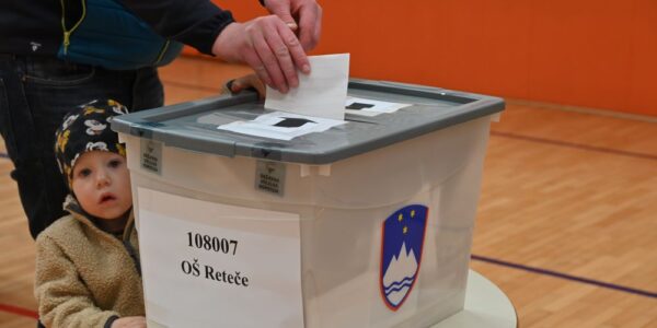 citizen voting with child watching
