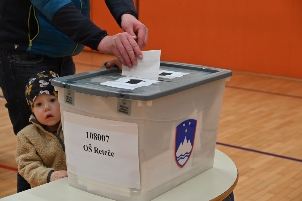 citizen voting with child watching