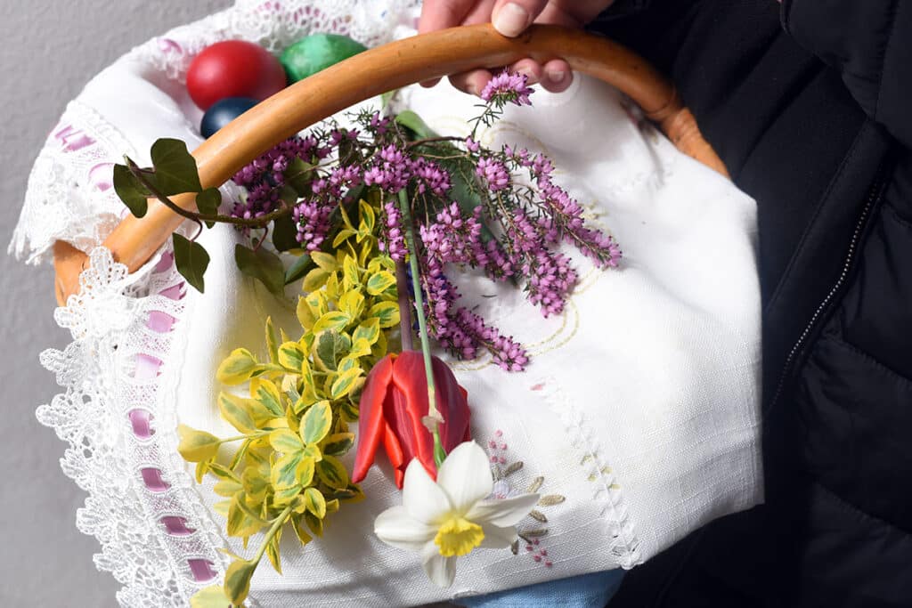 basket of flowers and easter eggs