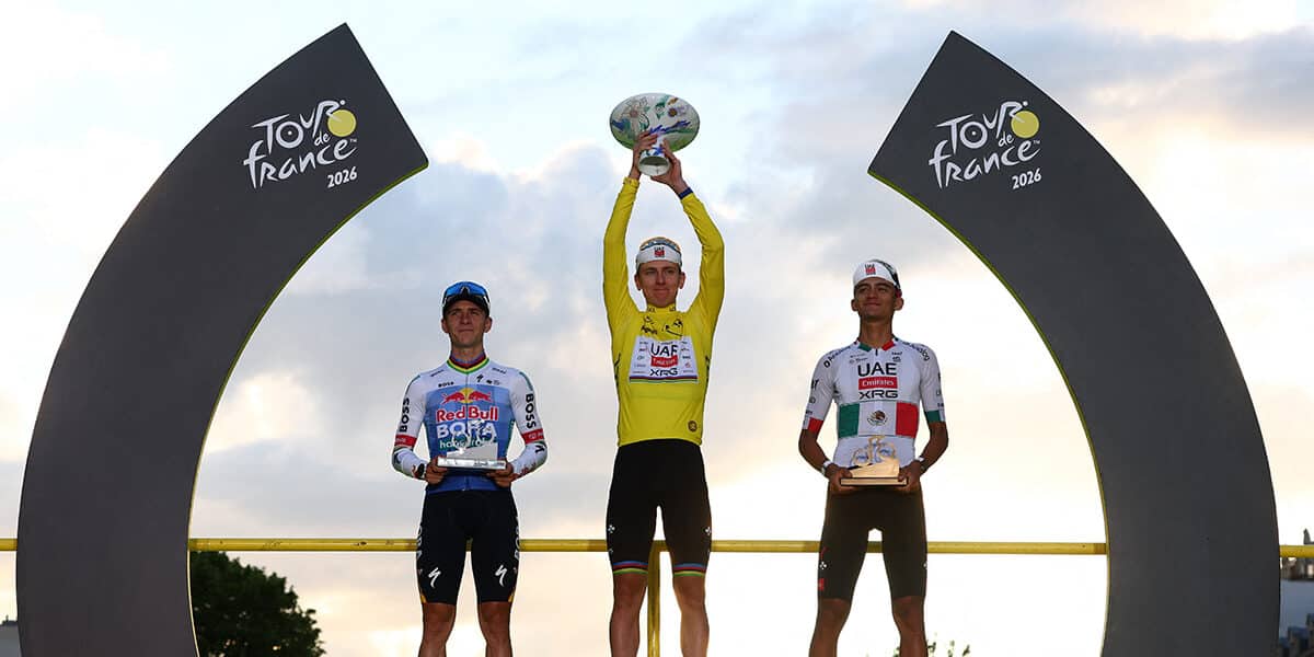 Cycling - Tour de France - Stage 21 - Paris, France - July 26, 2026 UAE Team Emirates XRG's Tadej Pogacar celebrates on the podium while wearing the yellow jersey after winning the Tour de France, alongside UAE Team Emirates XRG's Isaac Del Toro wearing the white jersey and Red Bull - BORA - hansgrohe's Remco Evenepoel REUTERS/Gonzalo Fuentes